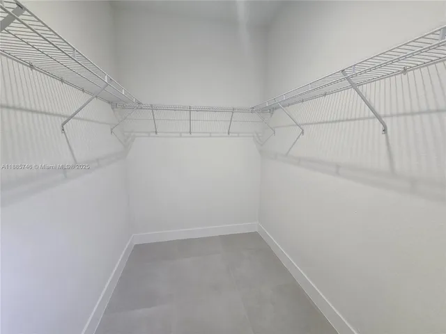 an empty room with windows and mirror