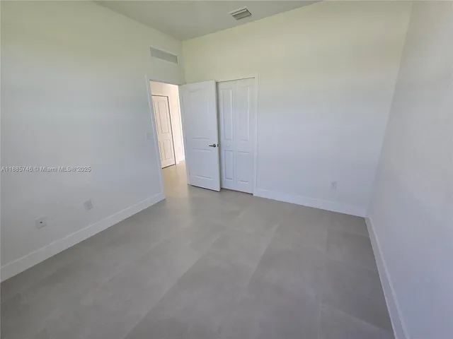 a bathroom with a toilet a sink a mirror and a shower