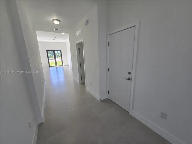 a kitchen with granite countertop a sink a stove and cabinets