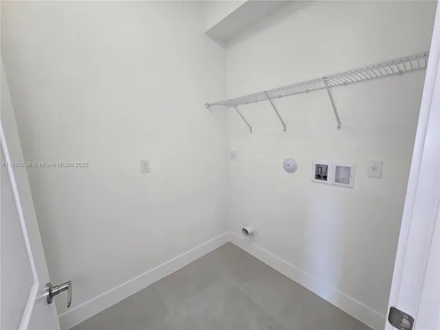 a kitchen with kitchen island a sink a stove and refrigerator