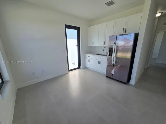 a spacious bathroom with a double vanity sink and a toilet