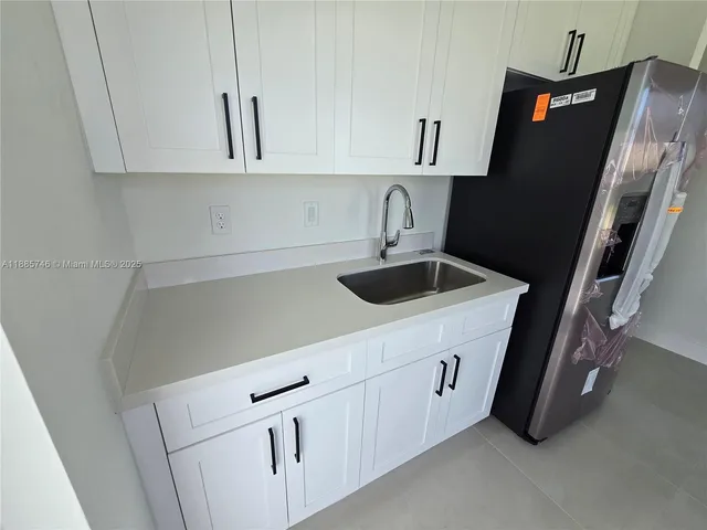 an empty room with a window and a fireplace