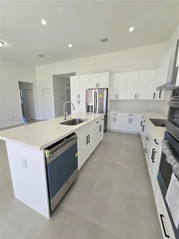 a view of a backyard with plants and a barbeque