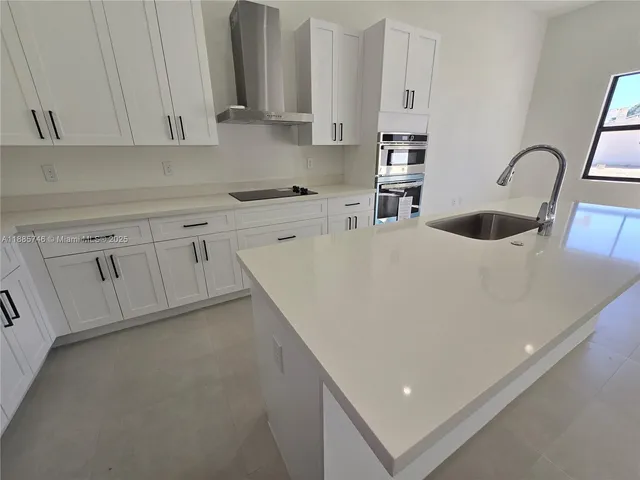 an empty room with windows and mirror