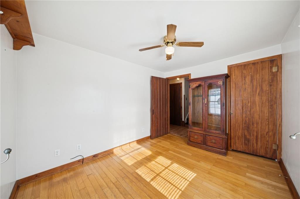 823 Arbor Lane Mount Pleasant, PA 15666 - Photo 15 of 37 a view of a room with wooden floor and ceiling fan