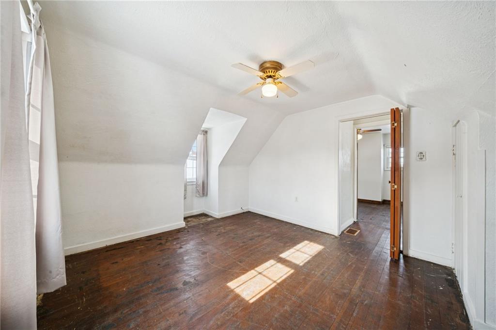 823 Arbor Lane Mount Pleasant, PA 15666 - Photo 18 of 37 an empty room with wooden floor and cabinet