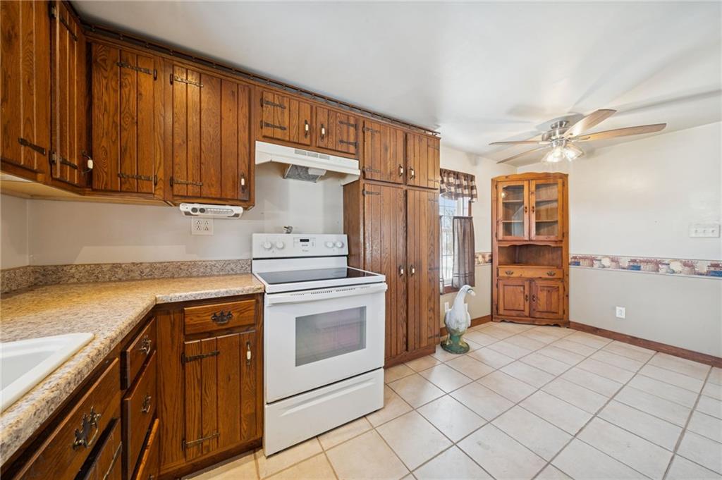 823 Arbor Lane Mount Pleasant, PA 15666 - Photo 4 of 37 a kitchen with stainless steel appliances granite countertop a refrigerator and a stove top oven