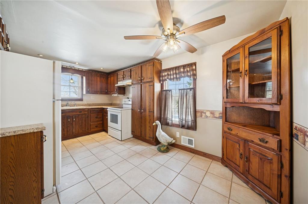 823 Arbor Lane Mount Pleasant, PA 15666 - Photo 9 of 37 a kitchen with a stove a sink and a refrigerator