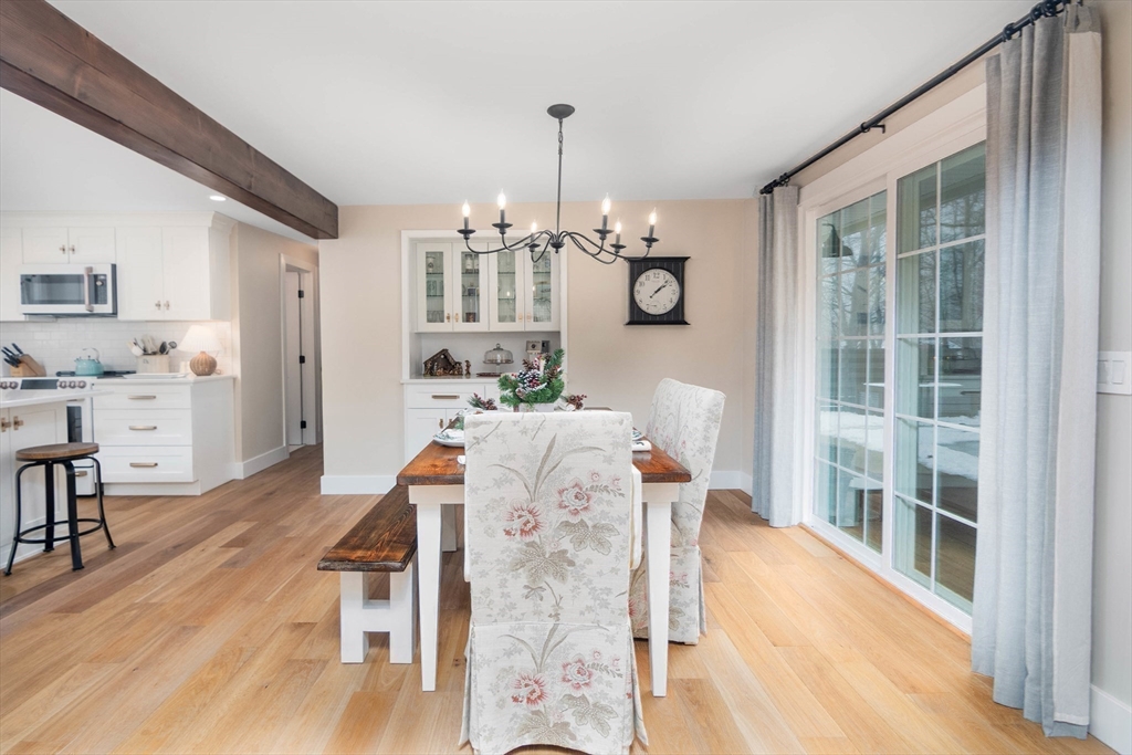 8 Edith Lane Rutland, MA 01543 - Photo 16 of 25 a living room with furniture dining table wooden floor and a chandelier