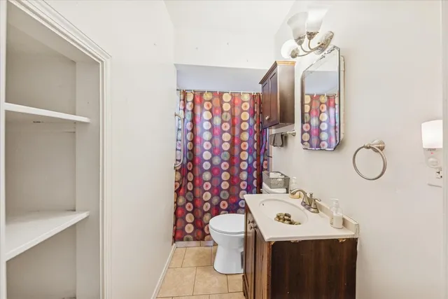 a bathroom with a sink mirror and toilet