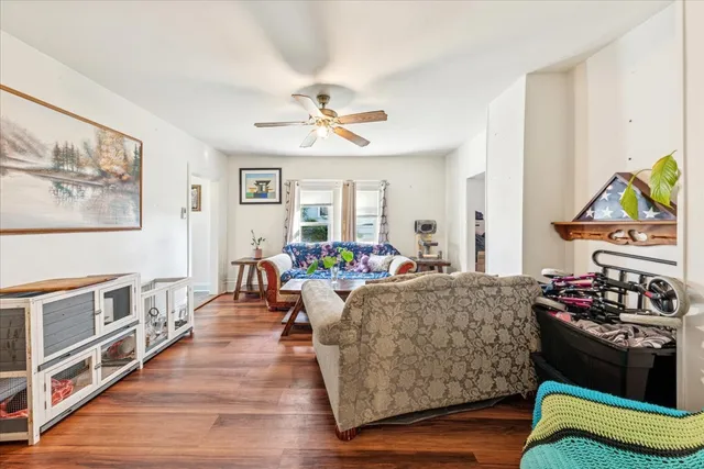 a living room with furniture and wooden floor