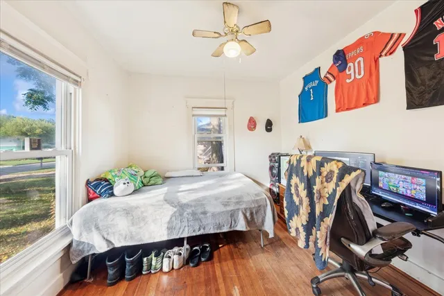 a bedroom with a bed a table and chair