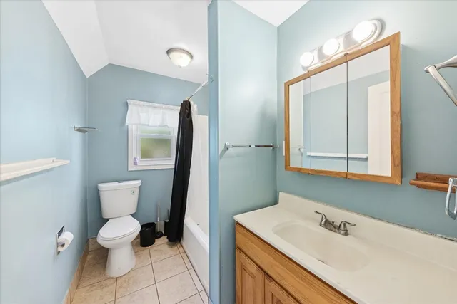 a bathroom with a sink toilet and mirror