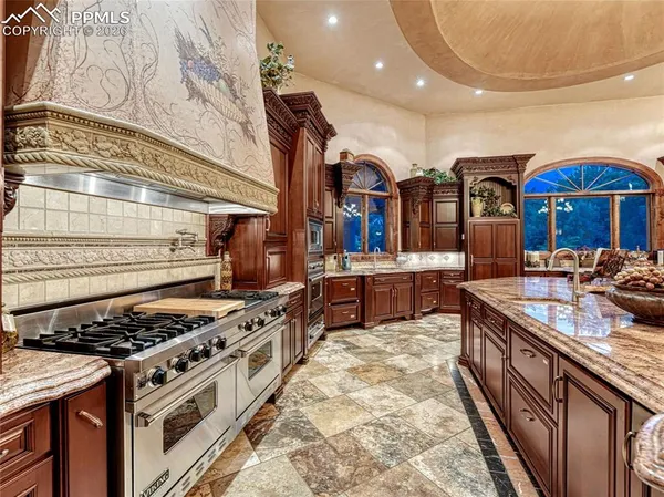 a kitchen with stainless steel appliances granite countertop a stove and a sink