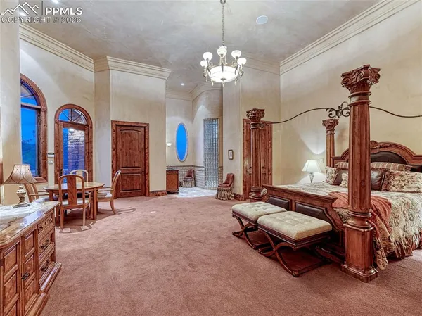 a bedroom with a bed and a chandelier