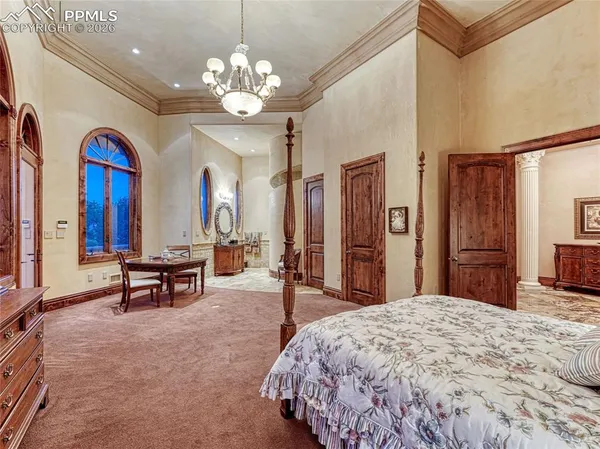 a living room with furniture a fireplace and a chandelier