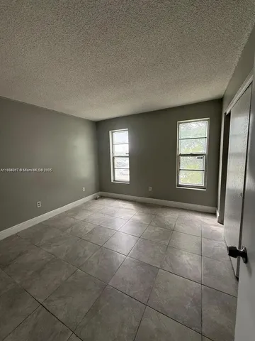 a view of an empty room with windows