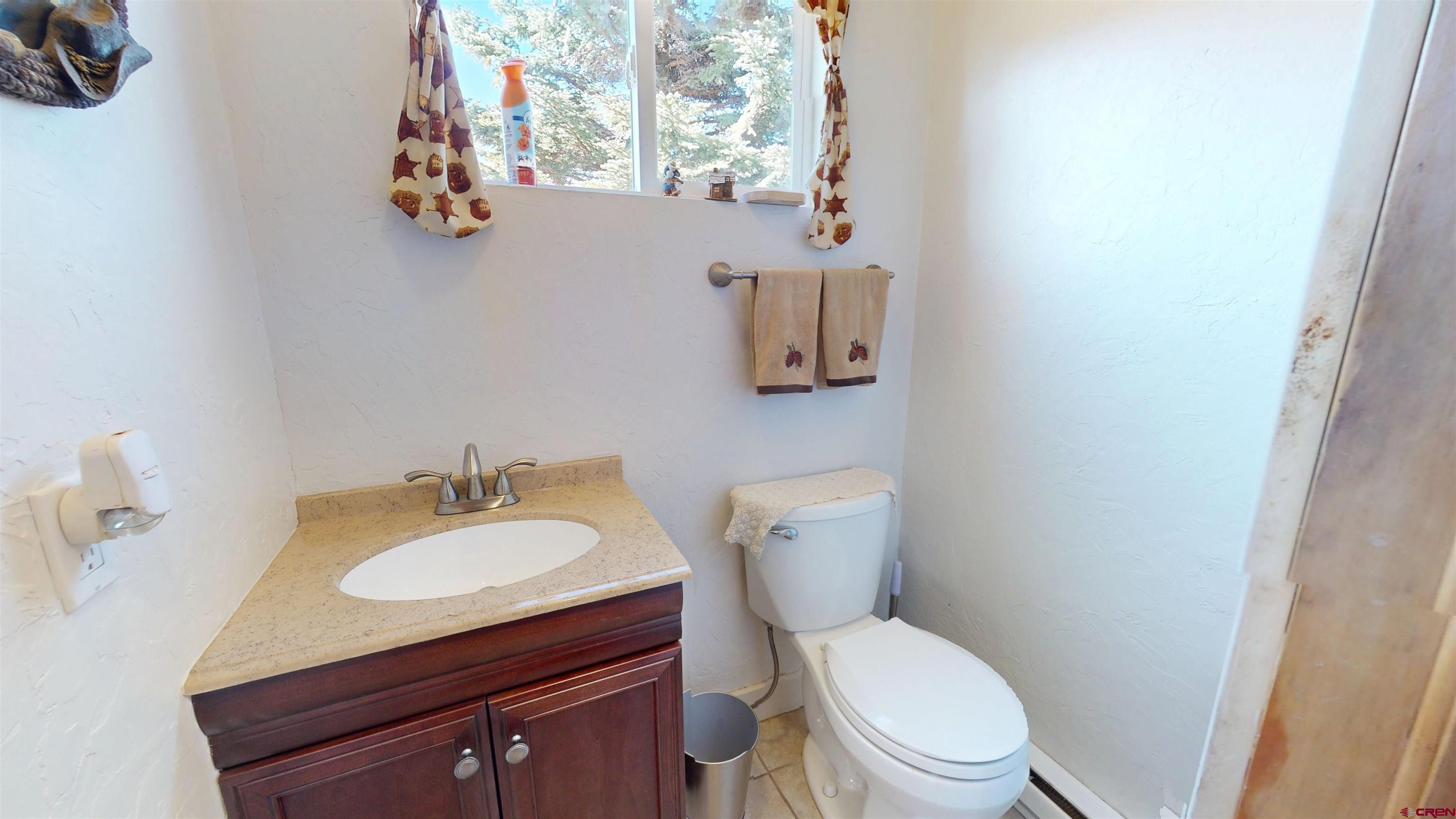 19253 Stevens Gulch Road Paonia, CO 81428 - Photo 29 of 43 a white toilet sitting next to a bathroom sink