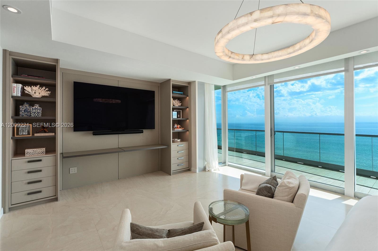 9349 Collins Avenue, Unit 801 Surfside, FL 33154 - Photo 23 of 59 a living room with furniture a flat screen tv and a floor to ceiling window
