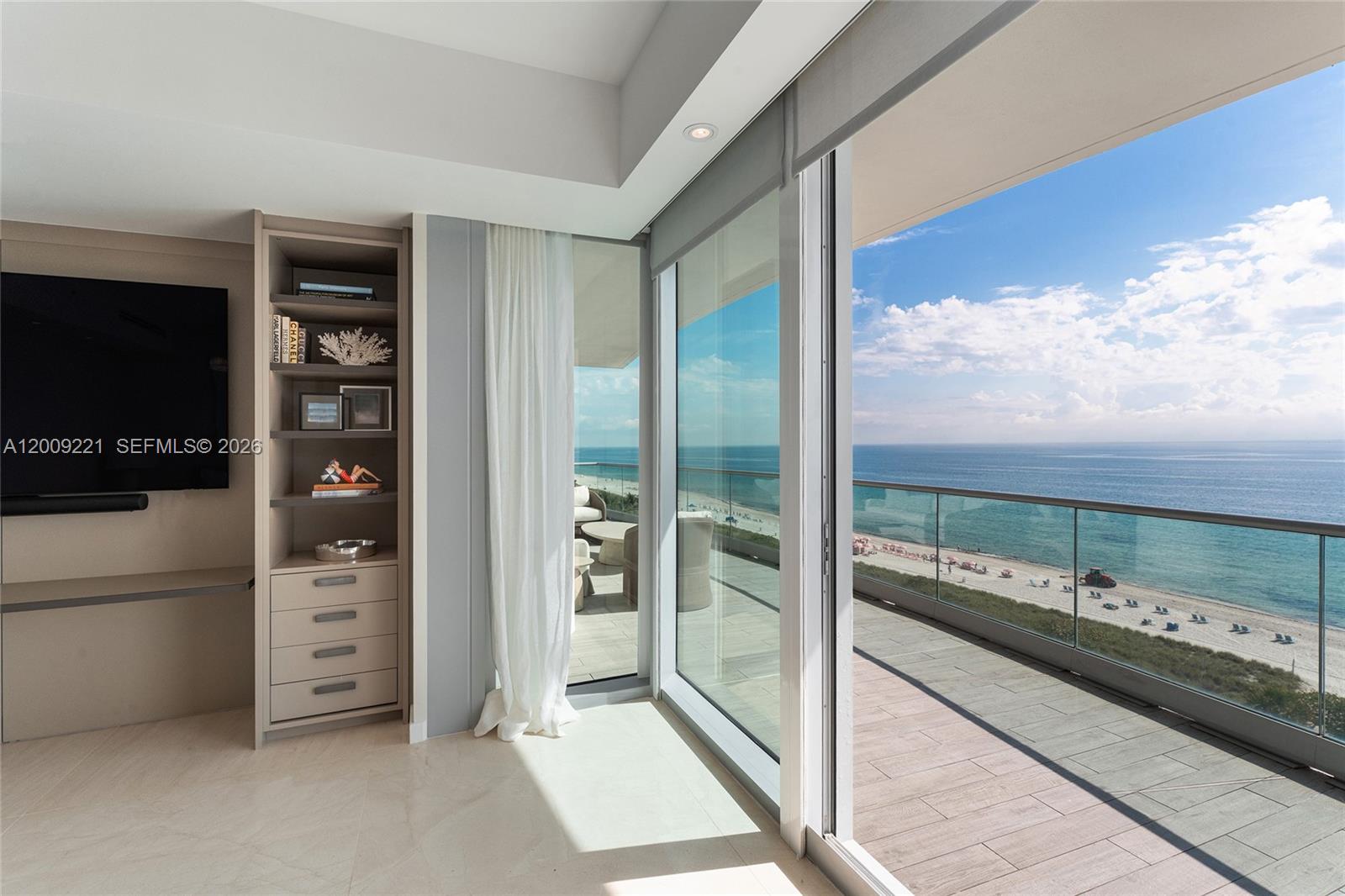9349 Collins Avenue, Unit 801 Surfside, FL 33154 - Photo 24 of 59 a very nice looking room with a large window and a flat screen tv