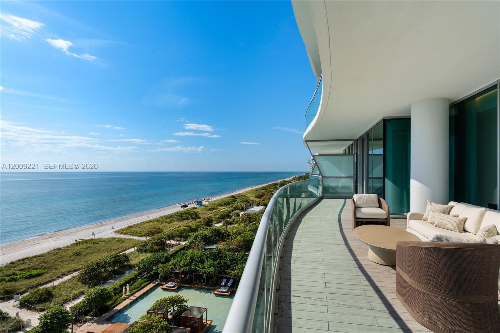 9349 Collins Avenue, Unit 801 Surfside, FL 33154 - Photo 25 of 59 a balcony with chairs and wooden floor