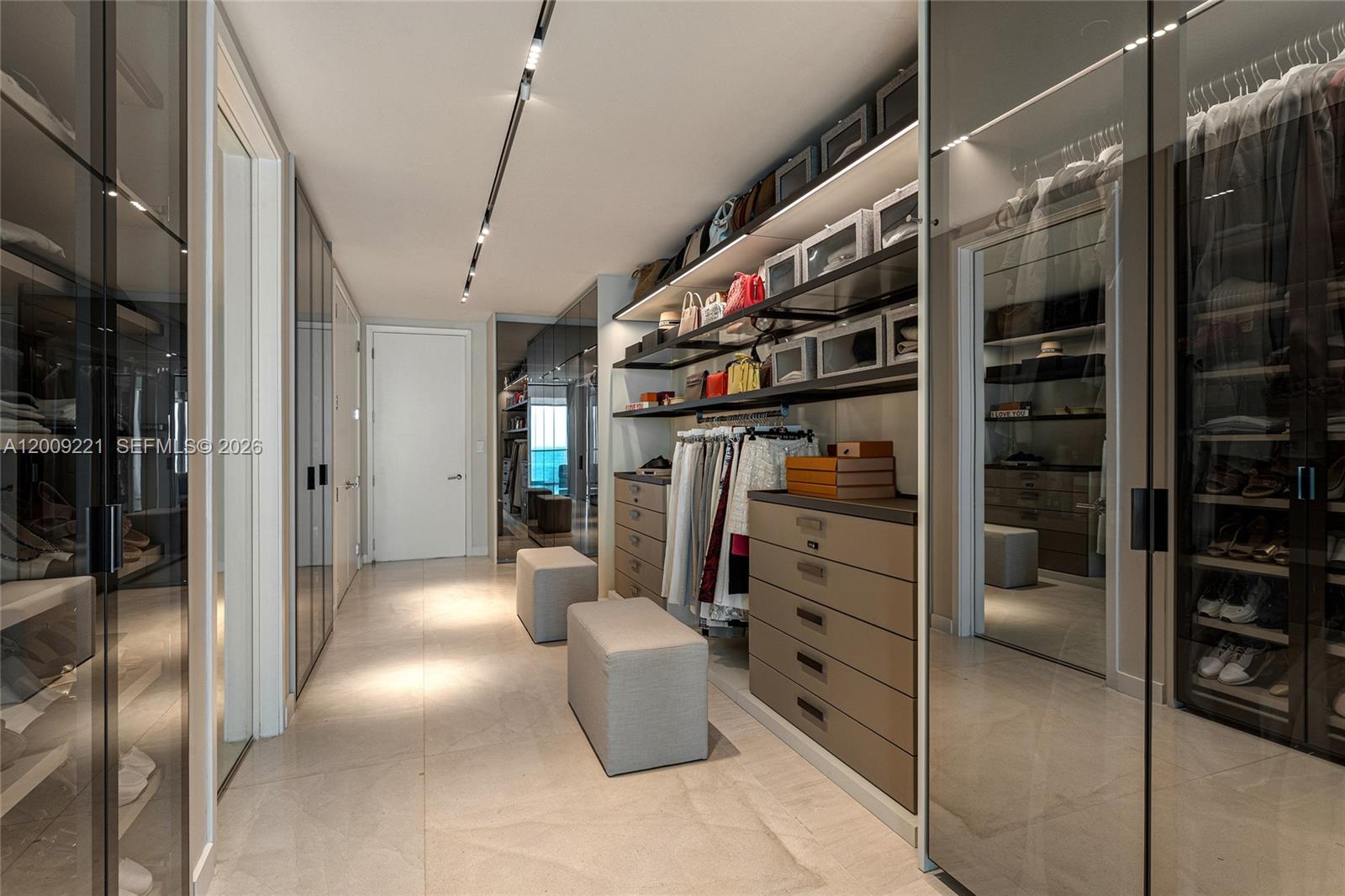 9349 Collins Avenue, Unit 801 Surfside, FL 33154 - Photo 32 of 59 a view of walk in closet with clothes and shoes
