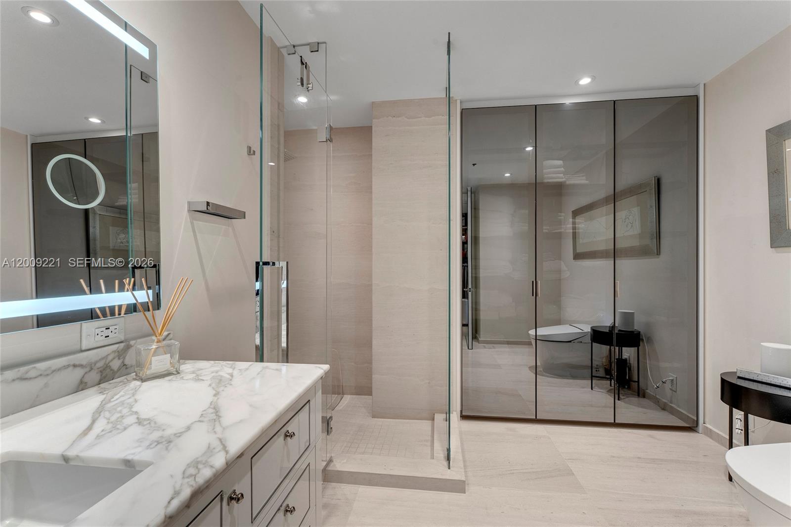 9349 Collins Avenue, Unit 801 Surfside, FL 33154 - Photo 35 of 59 a bathroom with a granite countertop sink mirror and shower