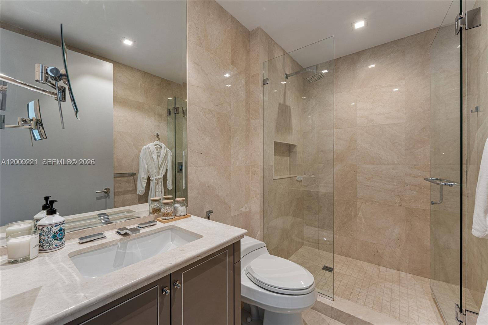 9349 Collins Avenue, Unit 801 Surfside, FL 33154 - Photo 43 of 59 a bathroom with a sink a toilet and shower