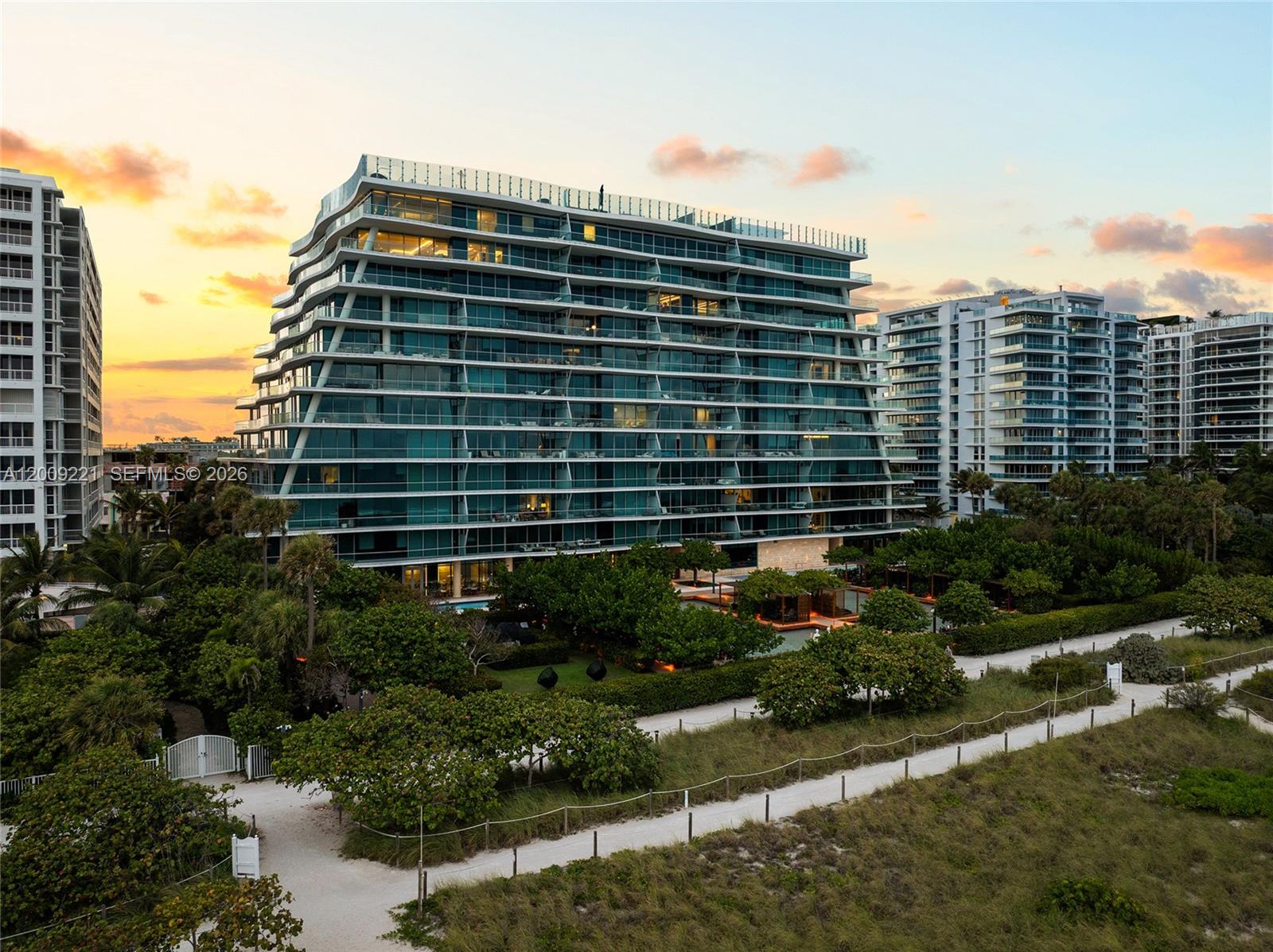 9349 Collins Avenue, Unit 801 Surfside, FL 33154 - Photo 58 of 59 a front view of a building with a yard