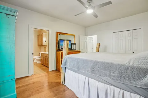 a spacious bedroom with a bed and a walk in closet