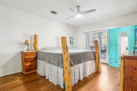 a bedroom with furniture and a wooden floor