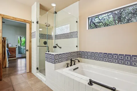 a bathroom with a bathtub and a shower