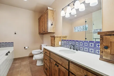 a bathroom with a sink a toilet and a mirror