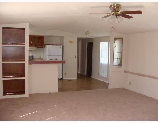 2521 Stanton Drive Corpus Christi, TX 78418 - Photo 3 of 9 a view of a kitchen with a microwave and a ceiling fan