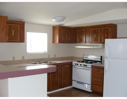 2521 Stanton Drive Corpus Christi, TX 78418 - Photo 4 of 9 a kitchen with a stove a sink and a window