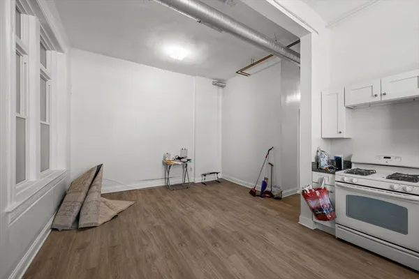 a room with a wooden floor and white walls