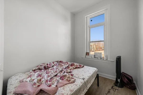 a bedroom with a bed and a window