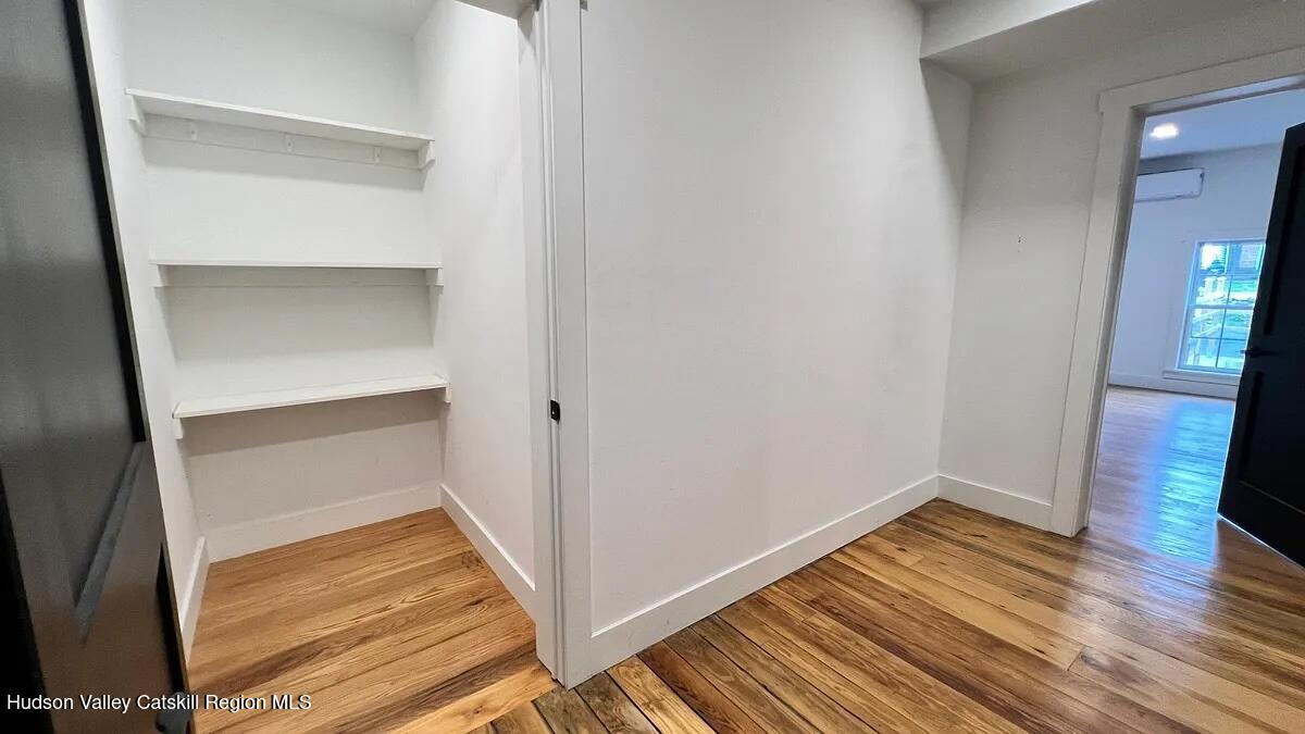 406 Main Street, Unit 2E Catskill, NY 12414 - Photo 21 of 28 a view of empty room with wooden floor
