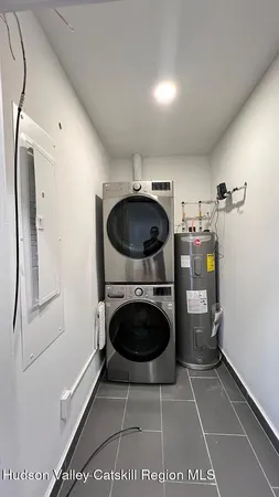 a bathroom with a washing machine and washing machine