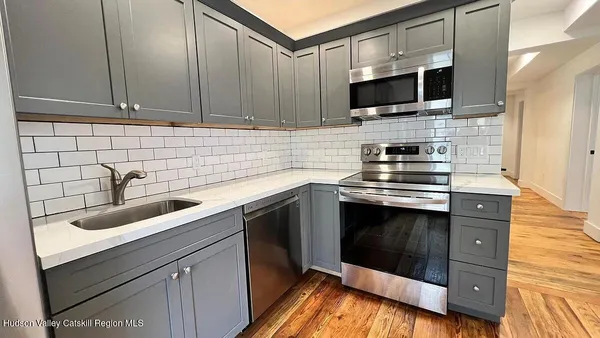 a kitchen with a sink stove and microwave