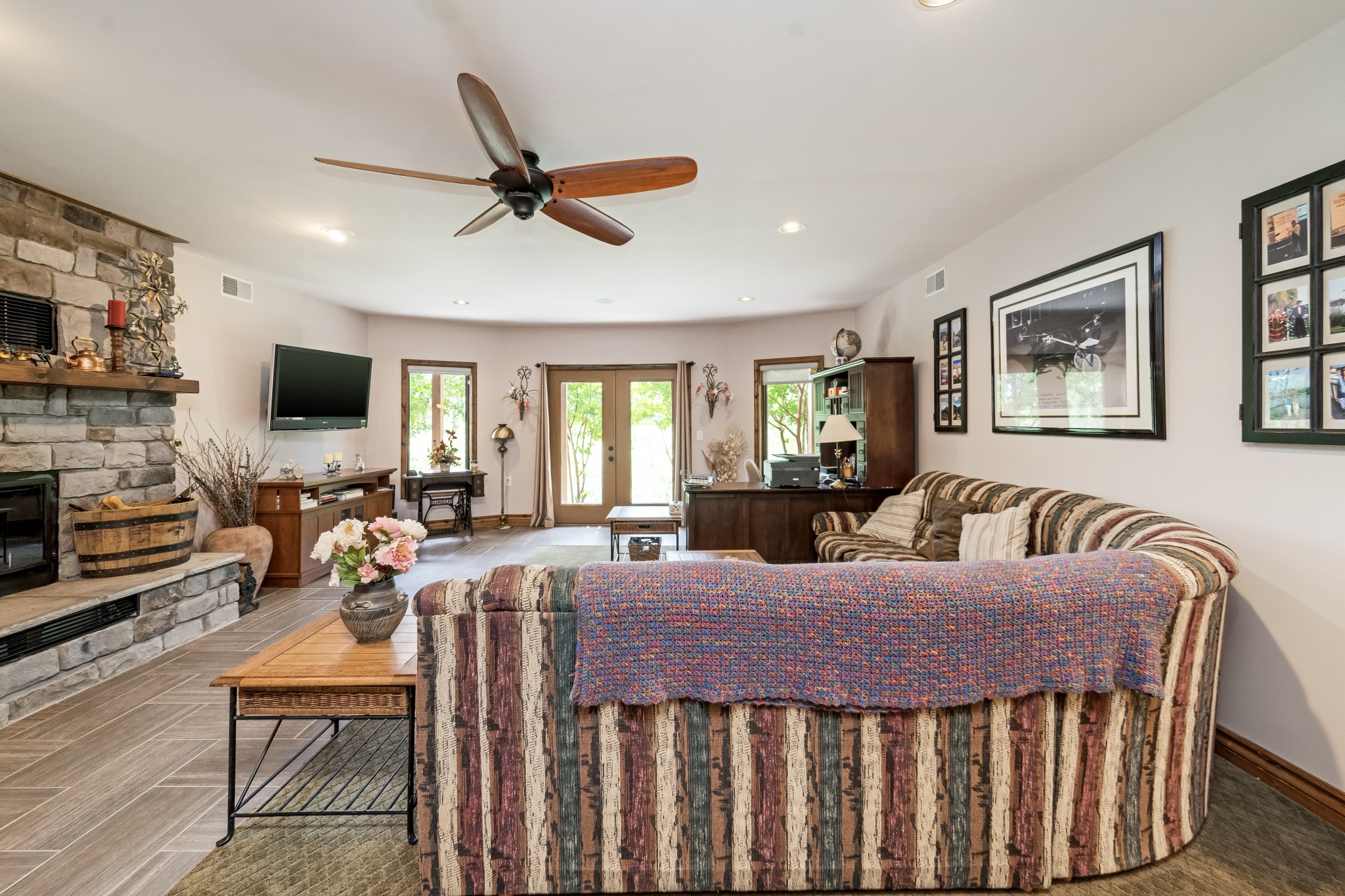 5564 Pinewood Road Franklin, TN 37064 - Photo 25 of 69 a living room with furniture a fireplace and a flat screen tv