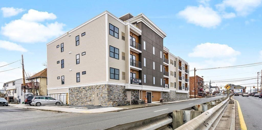 1133 North Shore Road, Unit 205 Revere, MA 02151 - Photo 13 of 20 a view of a tall building next to a road