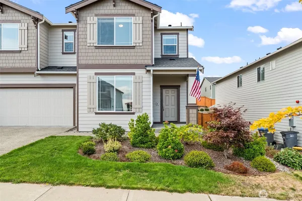 a front view of house with garage and yard