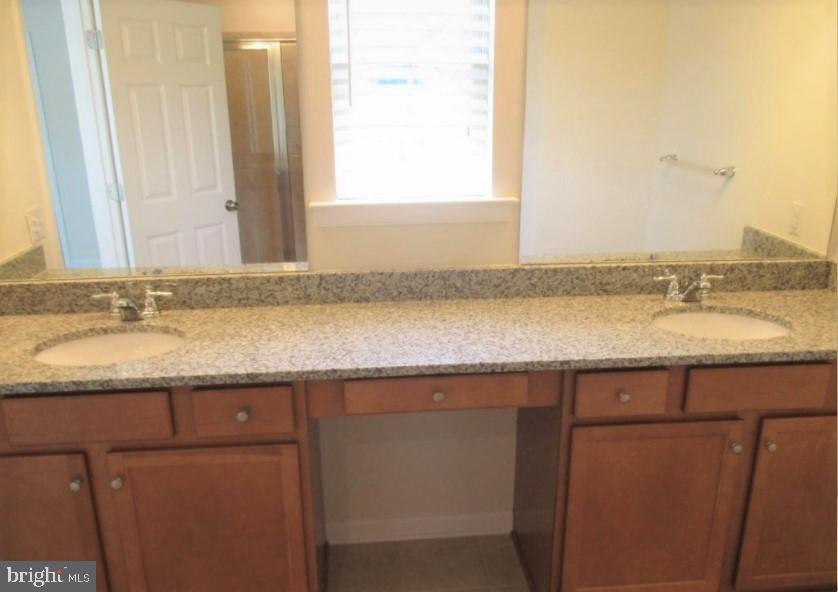 19 Eagle Lane Malvern, PA 19355 - Photo 14 of 20 a bathroom with a granite countertop sink and a mirror