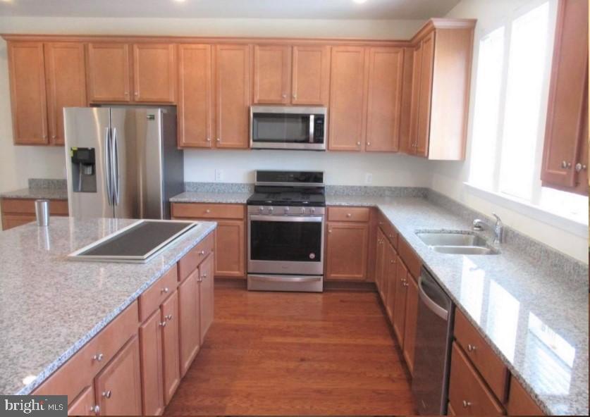 19 Eagle Lane Malvern, PA 19355 - Photo 7 of 20 a kitchen with stainless steel appliances granite countertop a stove a sink and a microwave