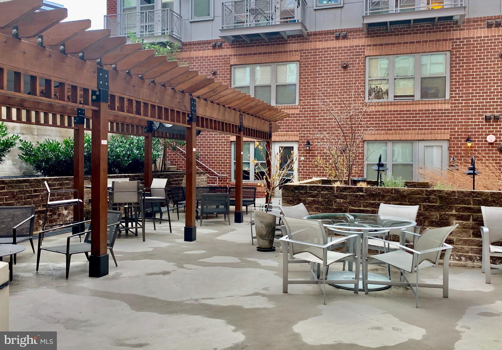 1300 N Street Northwest, Unit 508 Washington, DC 20005 - Photo 17 of 19 a view of a patio with couches table and chairs and potted plants