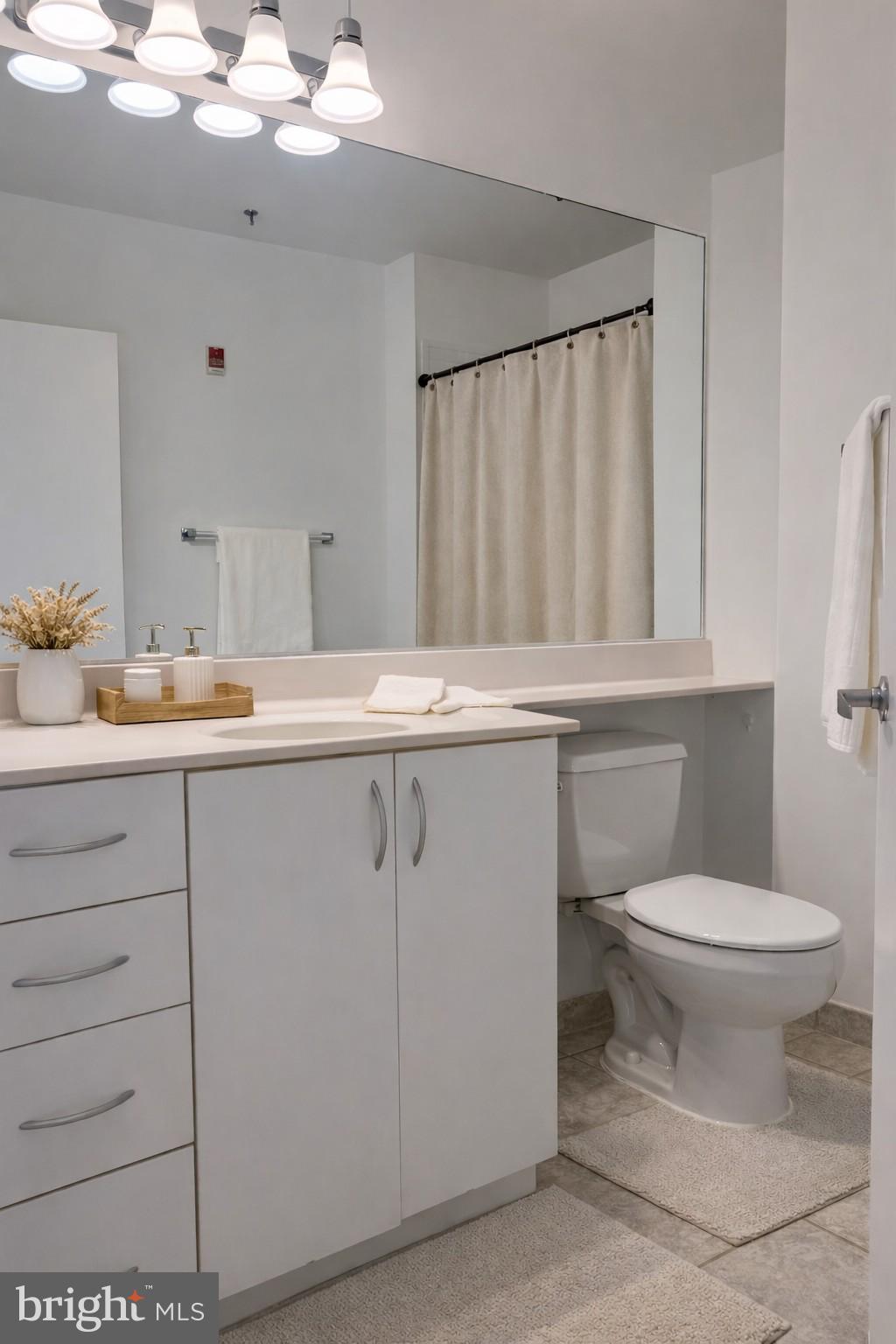 1300 N Street Northwest, Unit 508 Washington, DC 20005 - Photo 4 of 19 a bathroom with a sink a toilet and vanity