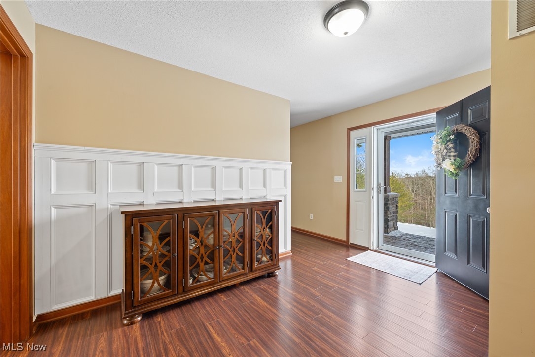 399 Wilder Road Vinton, OH 45686 - Photo 6 of 36 Entrance foyer featuring dark wood-style flooring and a textured ceiling