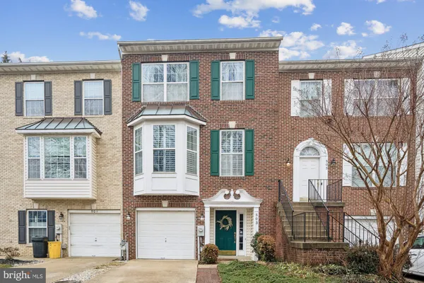 a front view of a residential apartment building with a yard