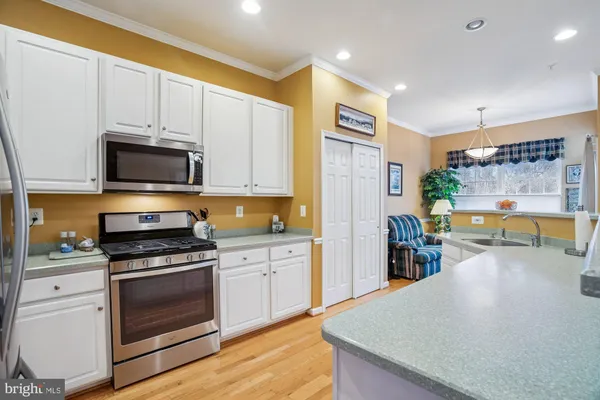 a kitchen with stainless steel appliances a stove microwave and cabinets